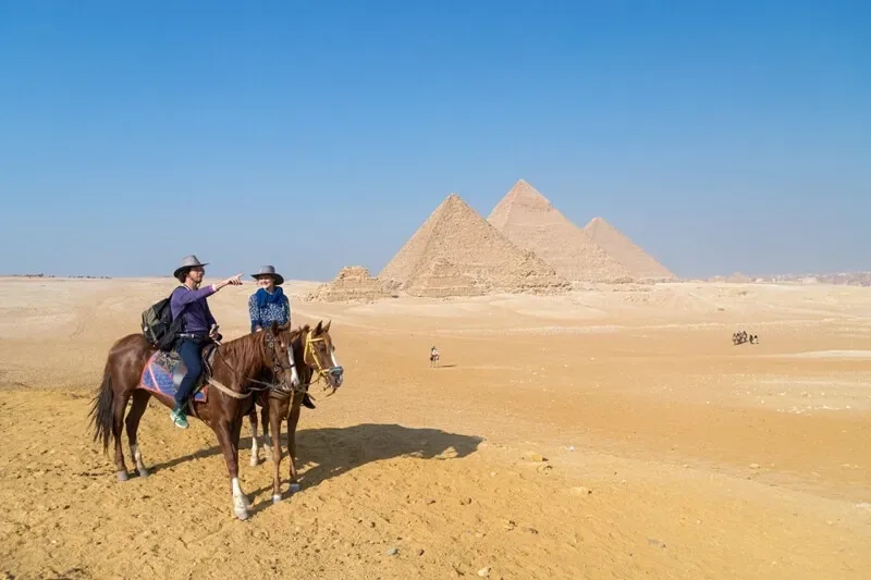 Horse ride panoramic viewpoint Giza — all three pyramids as your backdrop at sunset